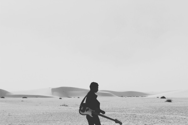 man with guitar in the desert